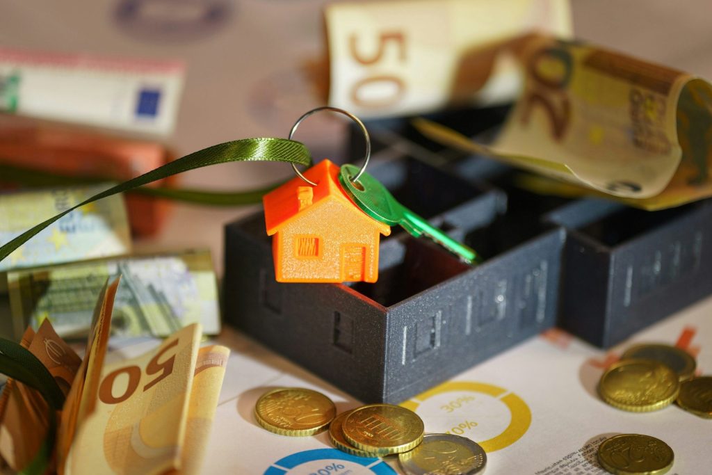 A small house on top of a pile of money