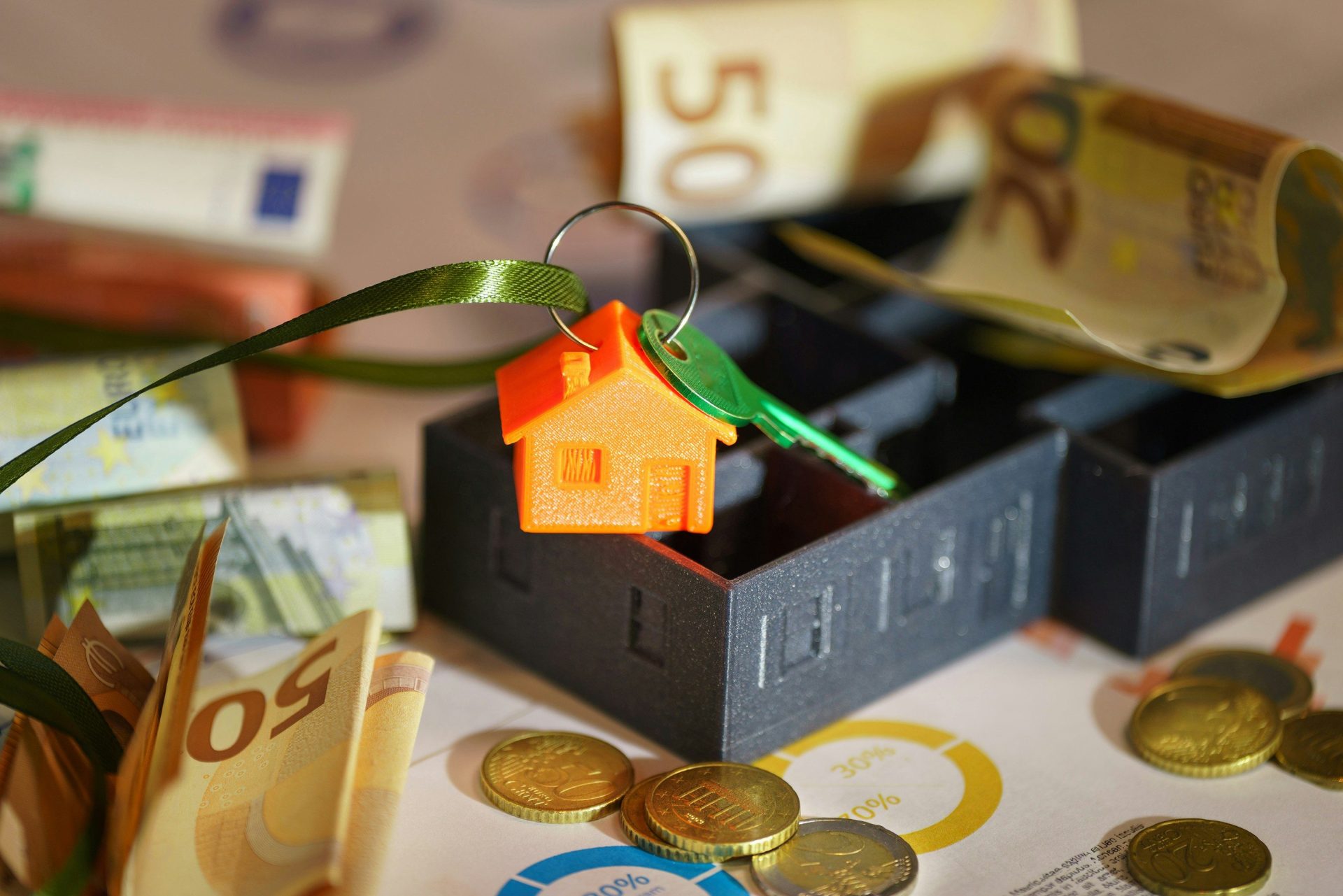 A small house on top of a pile of money
