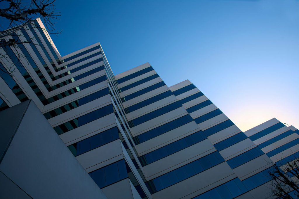 white and black concrete building under blue sky during daytime