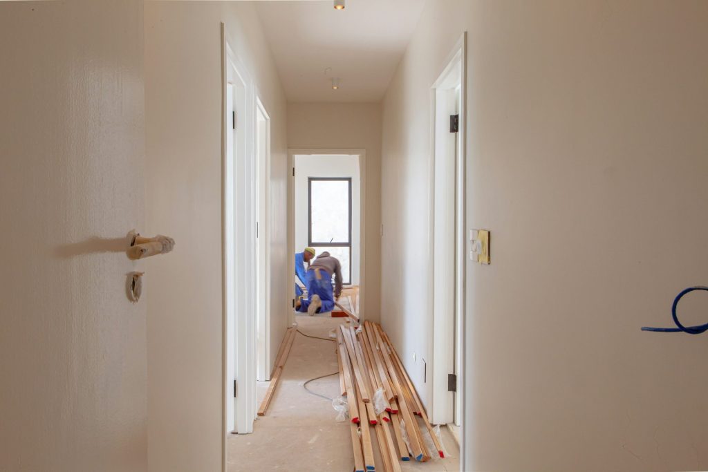 a couple of men working on a house